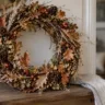 Großer selbst gebastelter Herbstkranz aus Zweigen, Blättern und Beeren als natürliche Herbstidee für den Eingang.